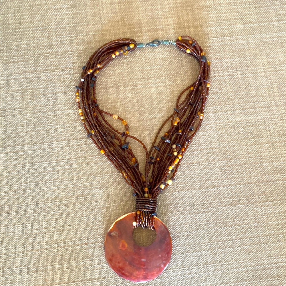 Large shell pendant beaded necklace.